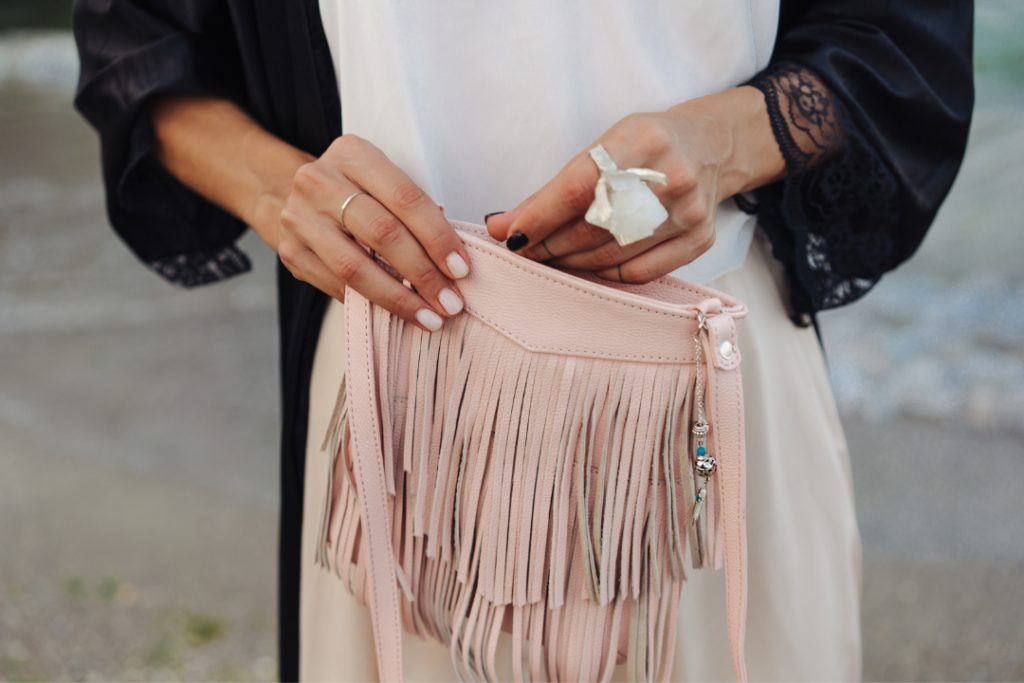 Woman holding a fringe bag