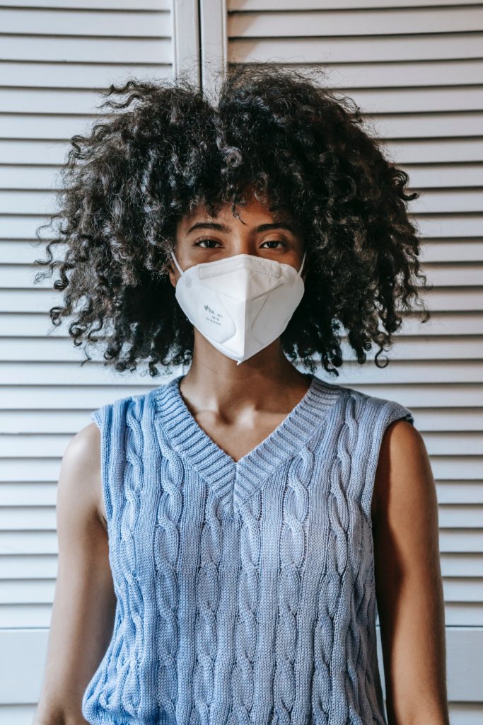 Photo of a woman wearing a sweater vest and a face mask, from Sora Shimazaki from Pexels.