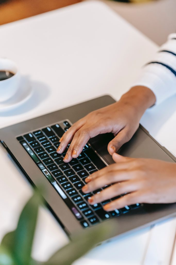 A woman typing on a keyboard. 