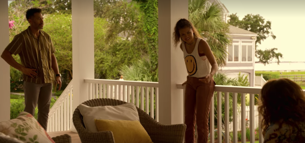 Outer Banks style Season 2: Photo of Kiara wearing a smiley face shirt and brown slacks