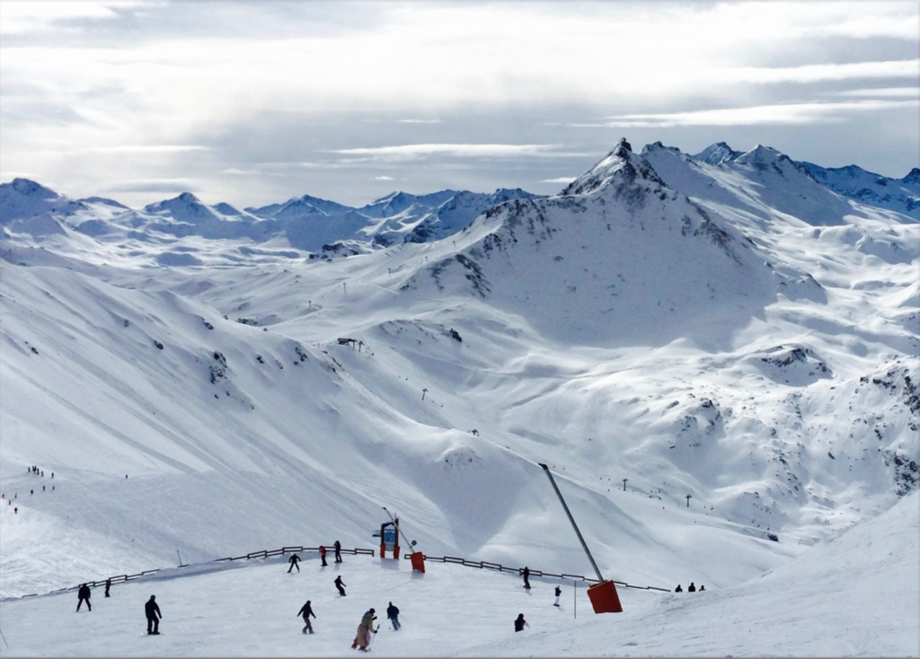 Skiiiers on snowcapped mountains