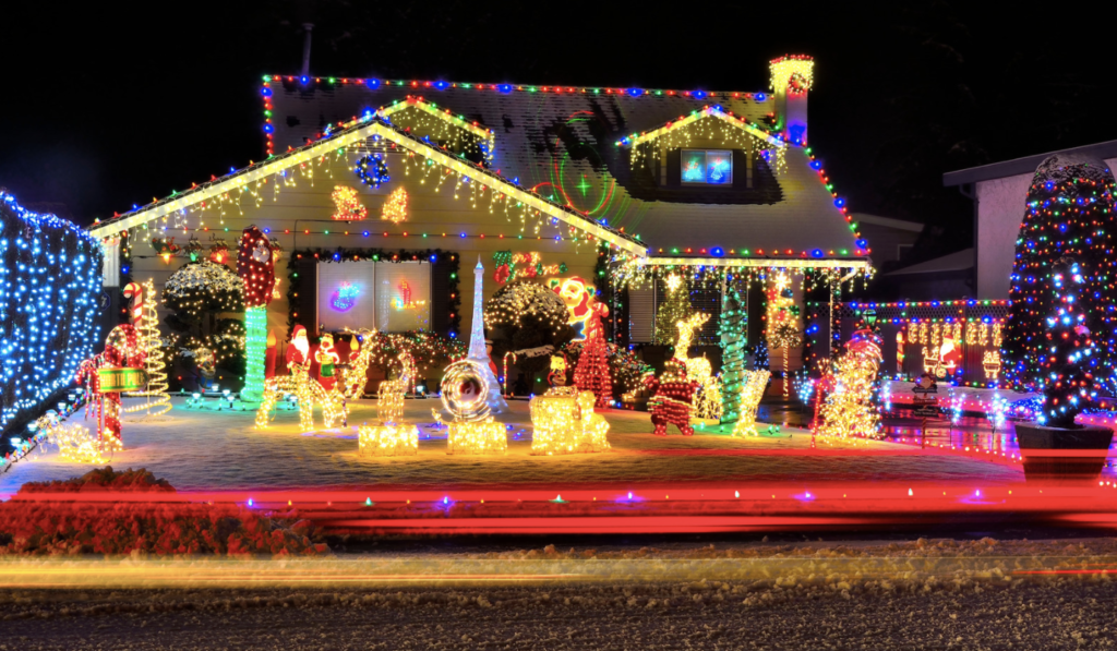 House with Christmas lights and light up scene in the yard.