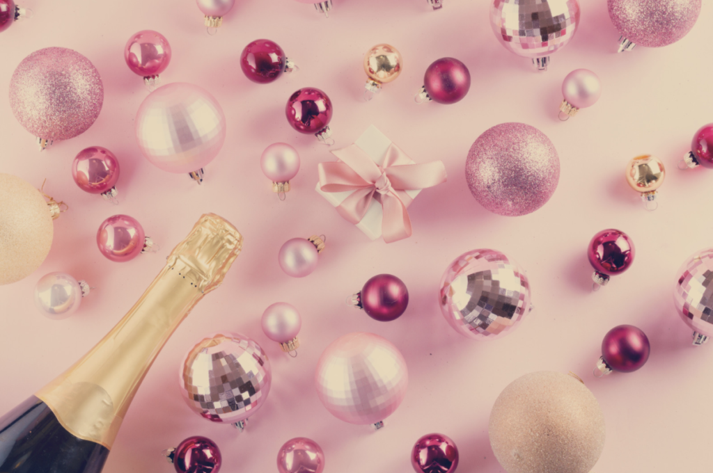 Pink shimmering ornaments and a bottle of unopened champagne.