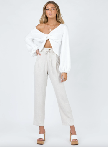 White balloon sleeve top with twist in front, hgh-waisted beige slacks, whtie and brown wedges
