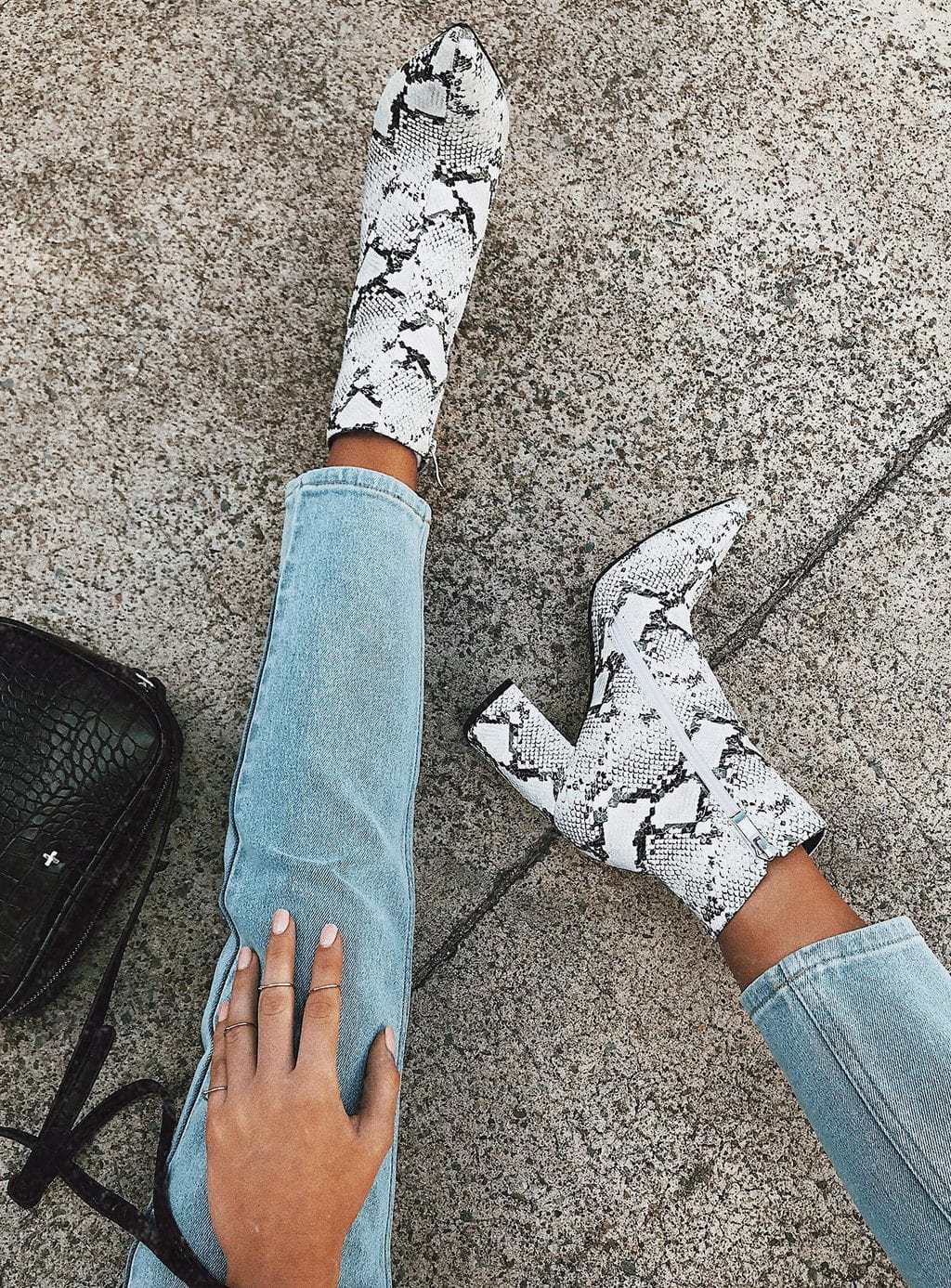 Woman feet wearing Cowboy Boots With Jeans