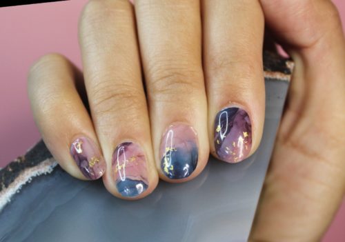 Marble nails in purple and pink with gold flecks
