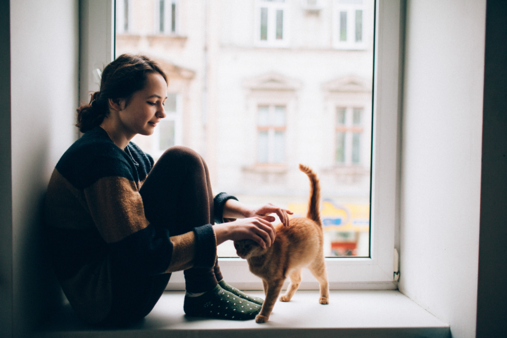 Photo of a woman pet sitting for a cat