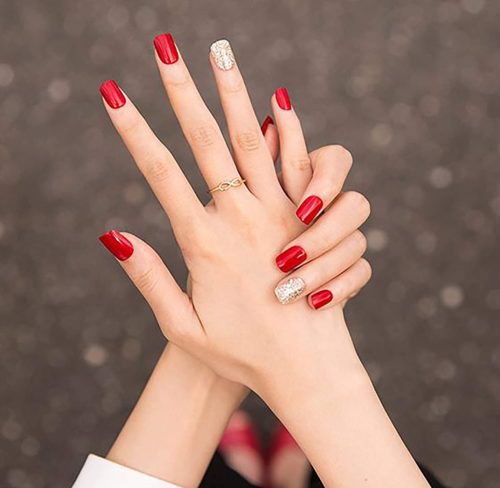 Short red nails with a gold glitter accent nail from amazon