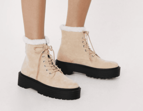 tan lace-up boots with white shearling lining and black chunky sole