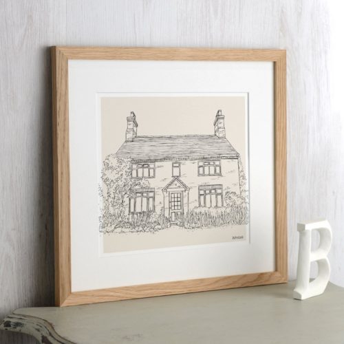 Custom house drawing framed in a wooden frame with a white mat