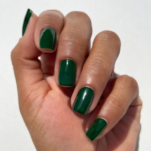 Photo of a hand with nails done in forest green nail polish, shade McKittrick by Cirque Colors