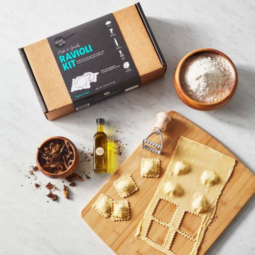 Photo of a DIY ravioli kit featuring a ravioli stamp, ravioli dough, an a mini bottle of olive oil