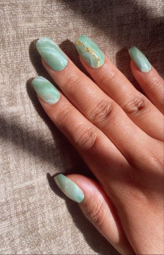 Green jade nails with a gold stripe on the accent nail