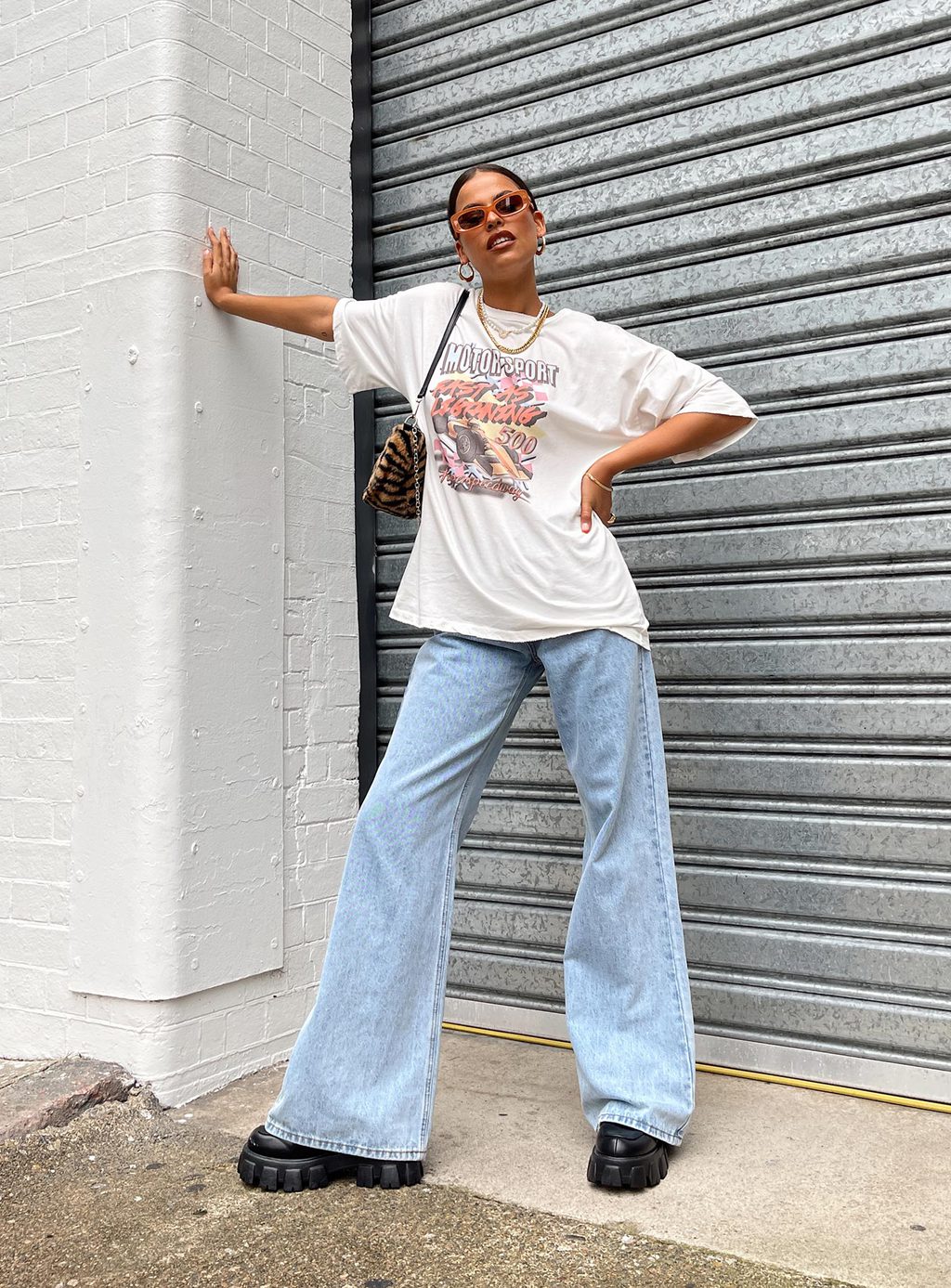 A woman standing on a baggy with a Big Tee & Wide Leg Jeans