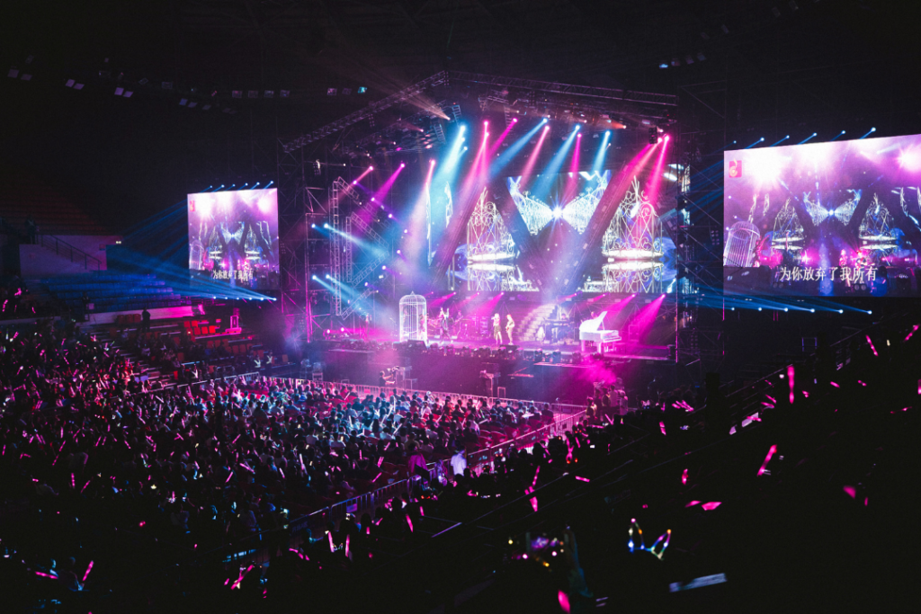 Photo of a concert with pink and blue lights