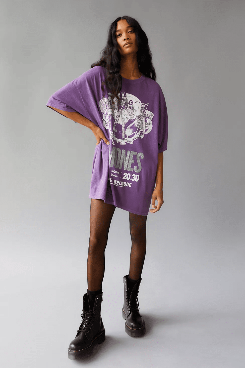 A woman wearing  a Baggy Graphic Tee as a Dress on purple color.