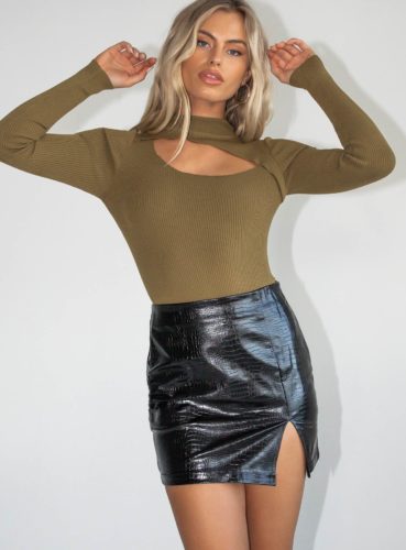 Cute outfit for winter with black faux leather mini skirt, brown cutout sweater, ankle boots