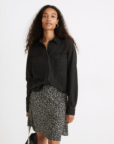 Dark denim chambray shirt worn with a floral skirt and a black mini bag