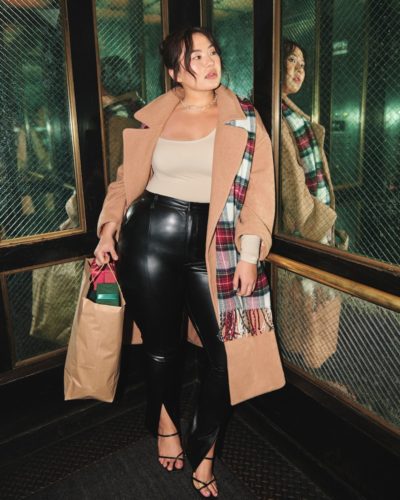 Model in an Abercrombie & Fitch Long camel coat, worn with leather pants and strappy heels