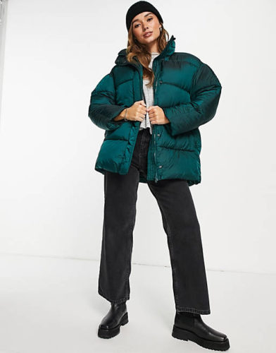 ASOS Puffer Coat in dark green paired with black wide leg jeans, a black beanie, and a gray long-sleeve t-shirt