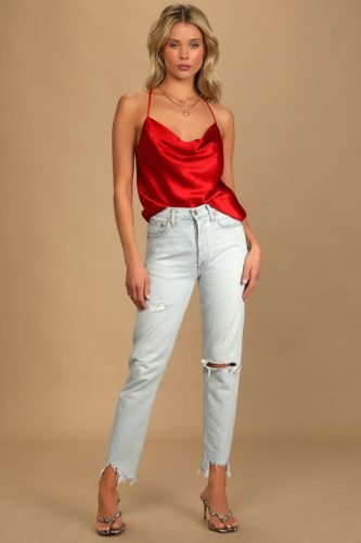 Lulus red satin top paired with light wash blue ripped jeans and snakeskin thong style heels