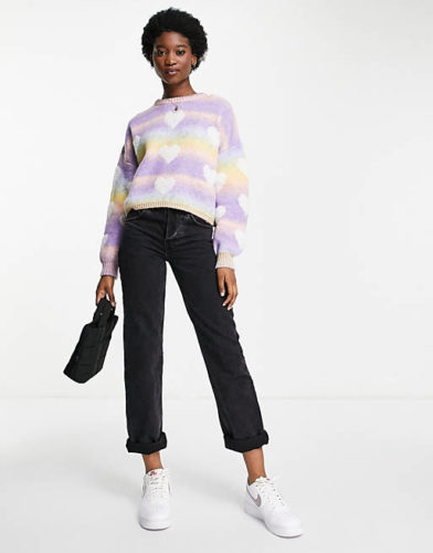 Asos Heart Sweater paired with black rolled-up jeans and simple sneakers