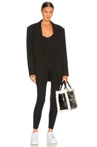 Revolve Catsuit in black paired with an oversized black blazer and white sneakers