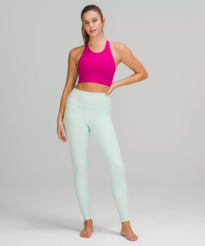 Photo of a model wearing Lululemon align leggings in mint with a neon pink sports bra