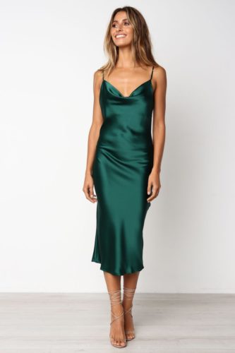 Minimalist Christmas party outfit with emerald green slip dress and nude strappy heels