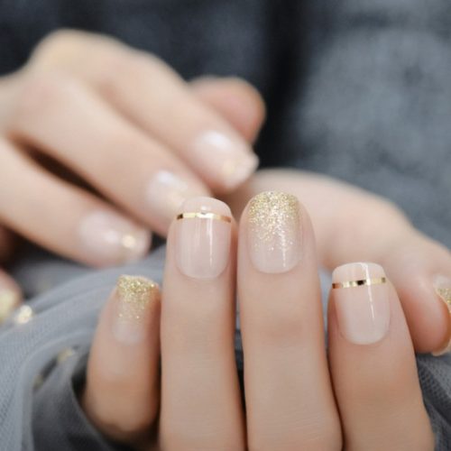 Nude nails with gold tips