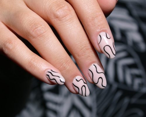 Nude nails with black squiggly line details