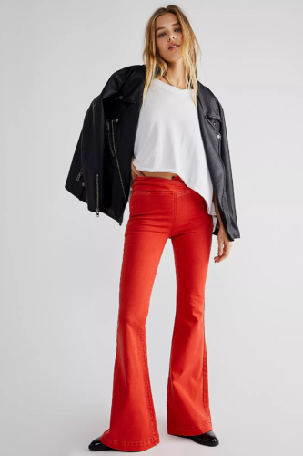 Bold red flare pants paired with slouchy white tee and oversized leather jacket
