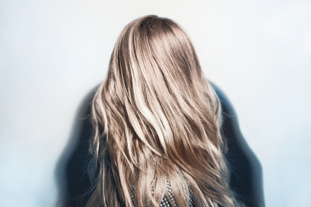 Photo of the back of a woman's head with bleached ash blonde hair
