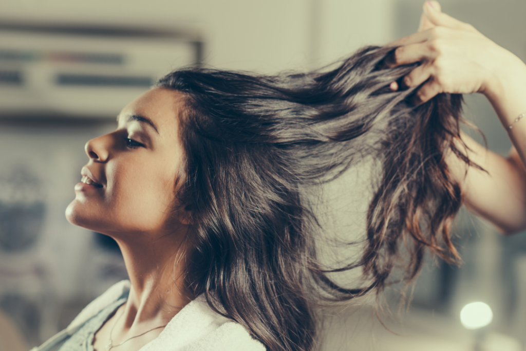 Photo of a woman with shiny, wavy, frizz-free hair