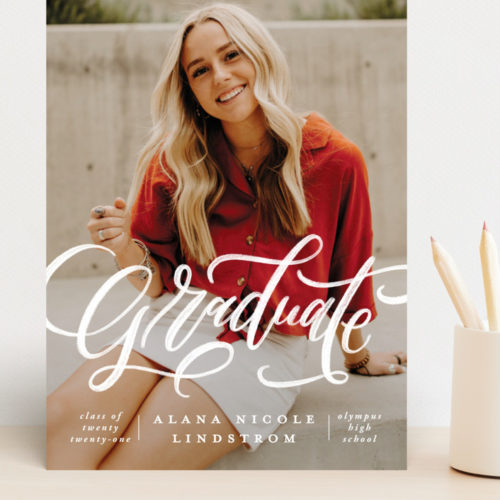 Graduation card from Minted that shows a young woman smiling with the word Graduate across her body.