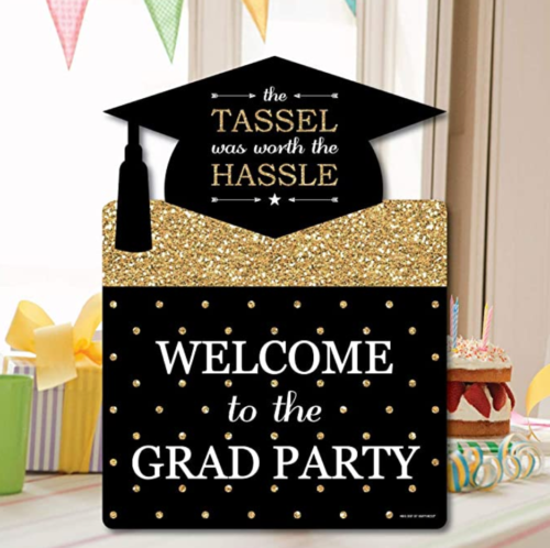 Graduation sign from amazon that reads: the tassel was worth the hassle. Welcome to the grad party.