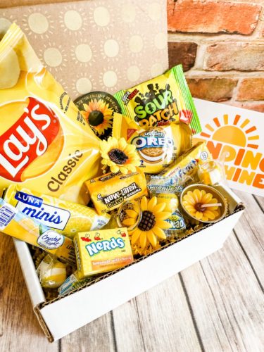 Little box of sunshine care package with candy and snacks