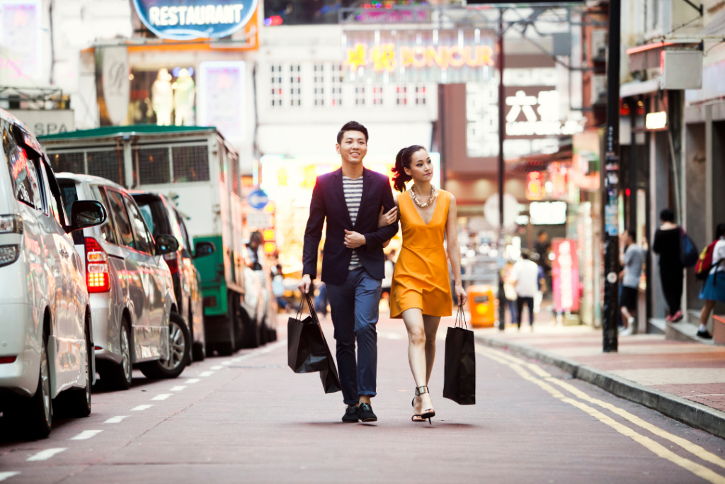 Picture of a couple walking on a street holding shopping bags