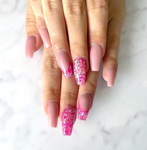Light pink nails with hot pink glitter accents
