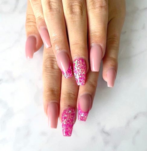Light pink nails with hot pink glitter accents