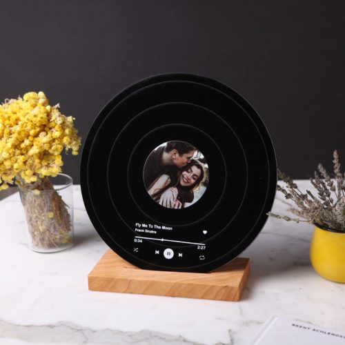 Personalized record keepsake with a couple's photo in the middle and their song written on the bottom