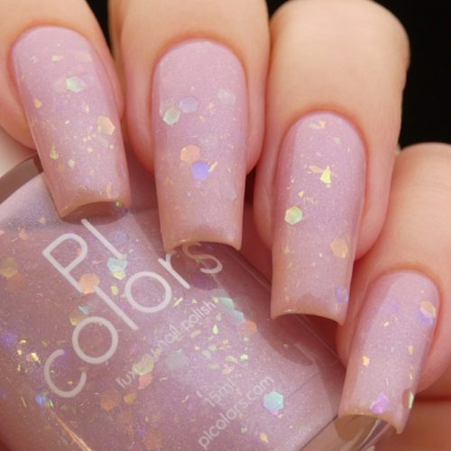 Pale pink nail polish with iridescent flakies and glitter