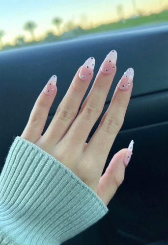 Baby pink acrylic nails with rhinestone detailing