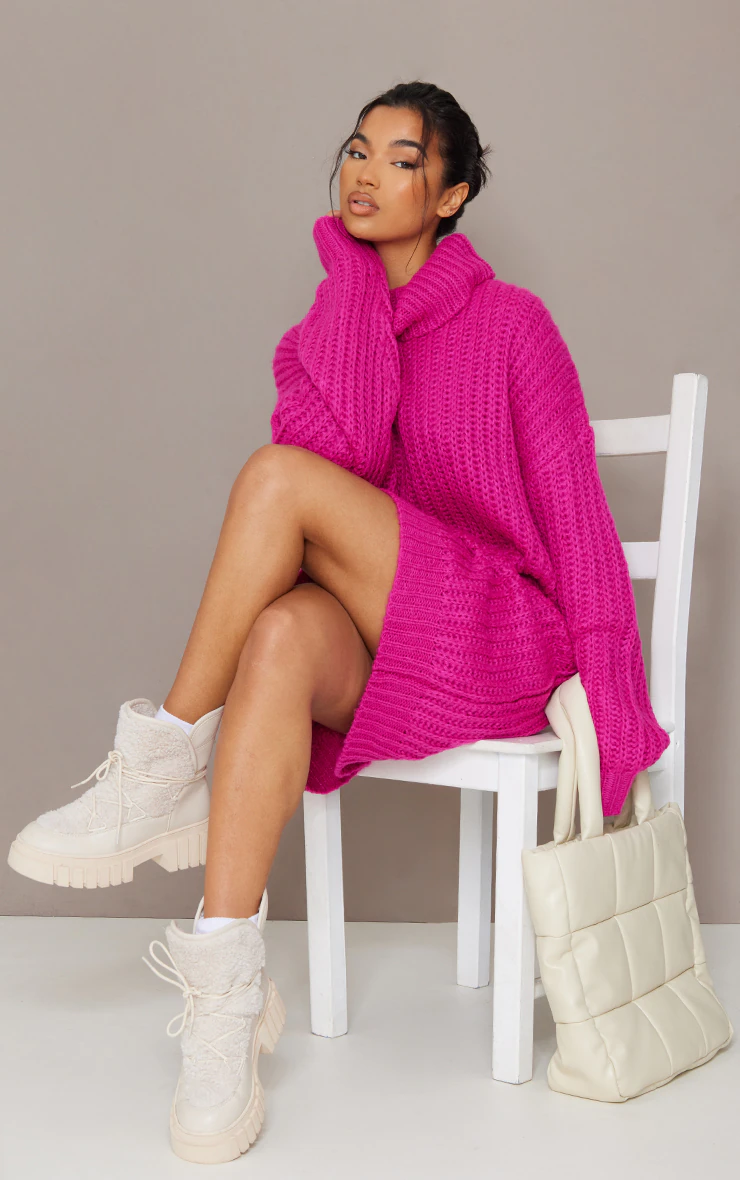 A woman sitting in a chair wearing a Pink Sweater Dress