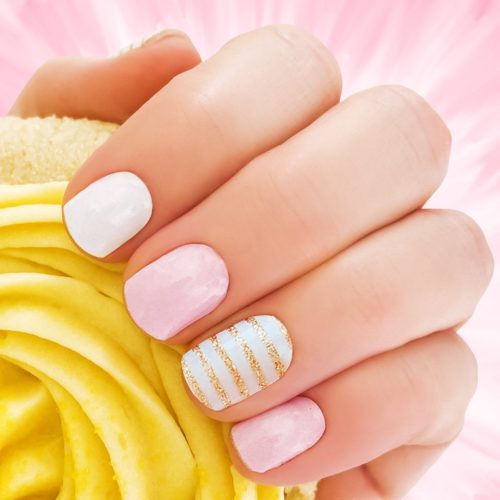 Pink and white nails with gold glitter stripes