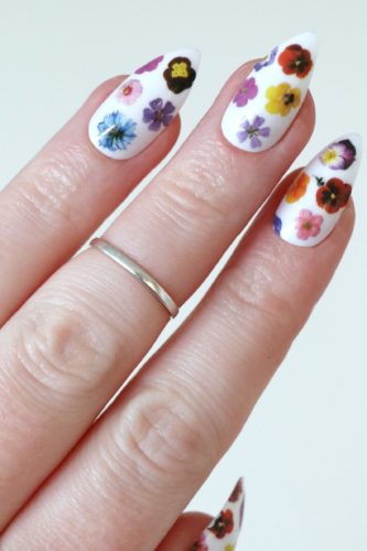 Colorful flower nail decals on white nails