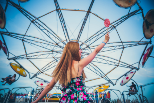 Woman in front of a ferris wheel