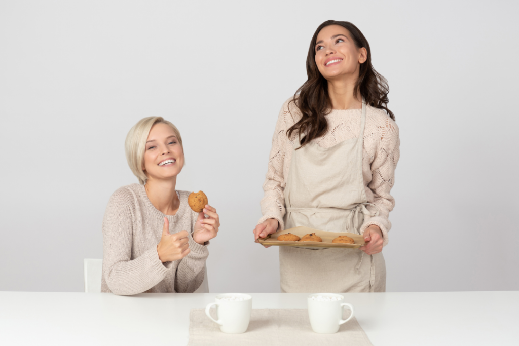 Photo of two women baking cookies together