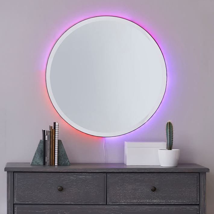 Backlit round mirror from West Elm lit up in red, purple, and pink