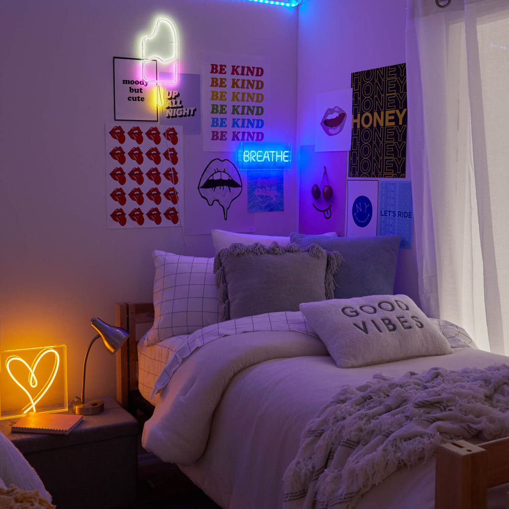 Room from Dormify decorated with neon signs in heart shape, popsicle shape, and a sign that says 